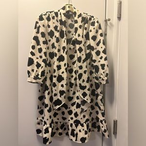 Black and white cow print stress with fun sleeves and a tie